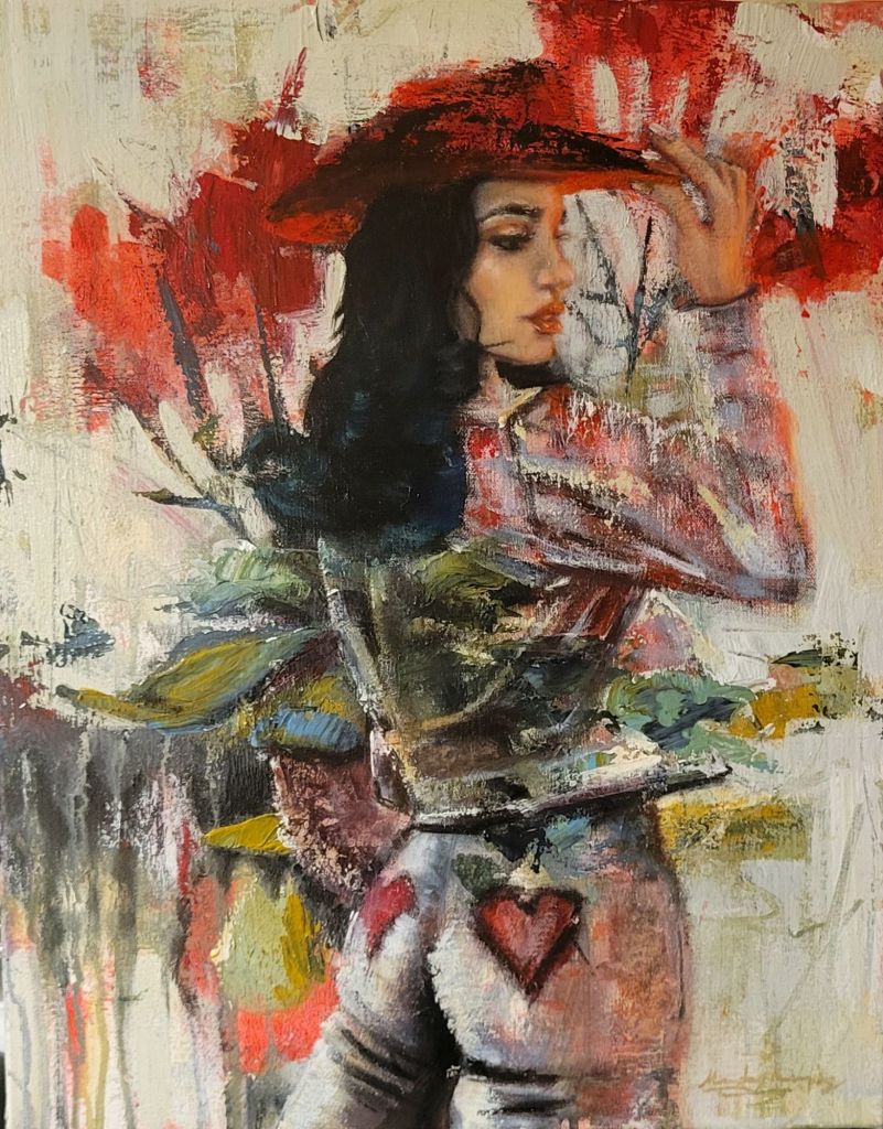 A cowgirl looks back over her shoulder wearing a bright red hat. Her western wear blends in the the abstract red flowers in the background.